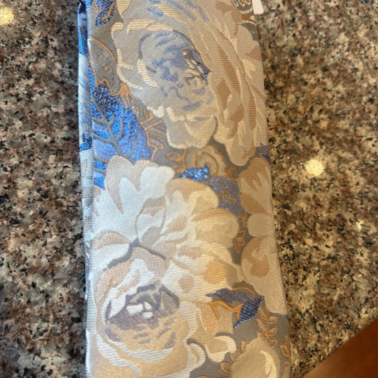 CREAM, BLUE AND TAN WITH BLUE MATALLIC FLOWERS TIE